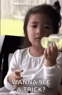Little Girl Holding Bottle Asking Wanna See A Trick GIF