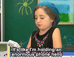 Little Girl Holding Phone Says It's Enormous