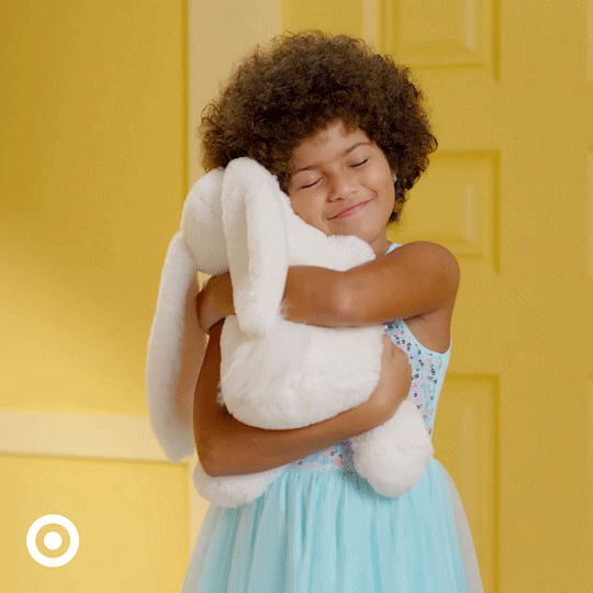 Little Girl Hugging Her Easter Bunny Toy GIF