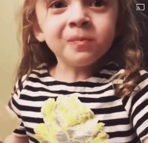 Little Girl in Black and White Striped Shirt Making a Face