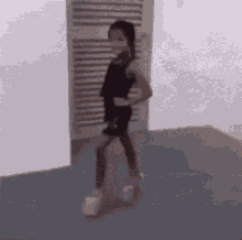 Little Girl In Black Dress And White Shoes At Door GIF