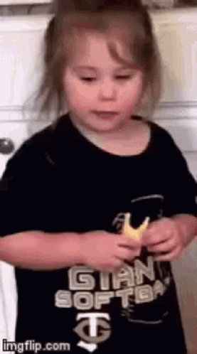 Little Girl in Black Shirt Holding Bread
