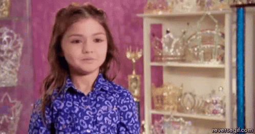 Little Girl in Blue Shirt at Tiara Display