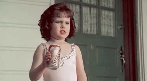 Little Girl in Dress Holding Soda