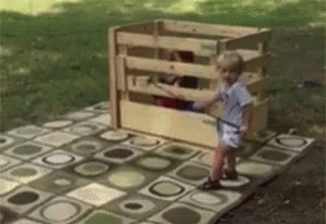 Little Girl in Front of Wooden Fence