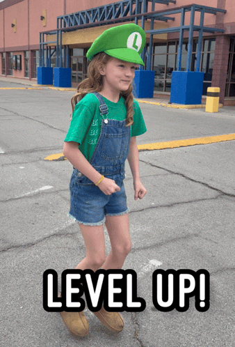 Little Girl in Green Hat with L Saying Level Up