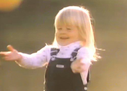 Little Girl in Overalls Smiling