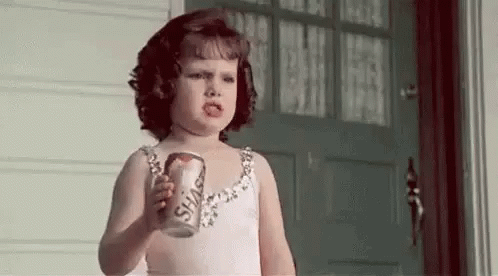 Little Girl in Pink Dress Holding Soda