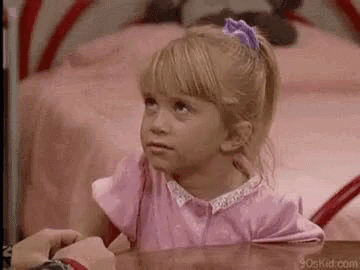 Little Girl in Pink Dress Sitting at Table