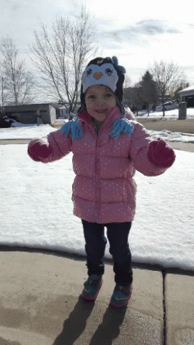 Little Girl in Pink Jacket and Penguin Hat