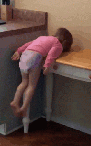 Little Girl In Pink Shirt Standing On Table GIF