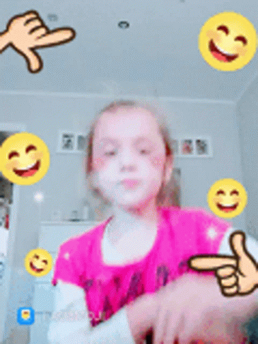 Little Girl In Pink Shirt Surrounded By Yellow Smiley Faces GIF