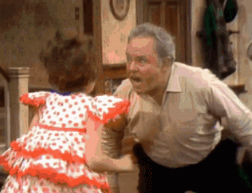 Little Girl in Polka Dot Dress Dancing With Older Man