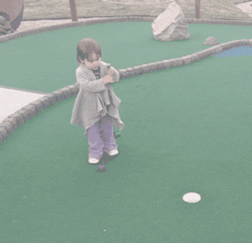 Little Girl in Purple Pants Playing Golf