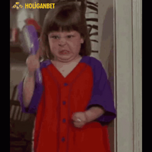 Little Girl In Red And Purple Shirt Making Funny Face GIF