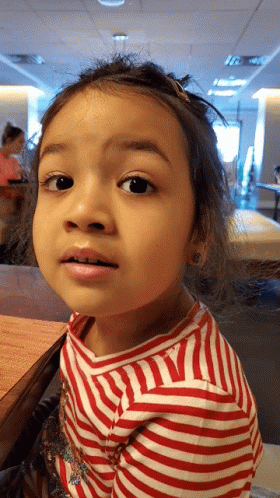 Little Girl in Red and White Striped Shirt Looking