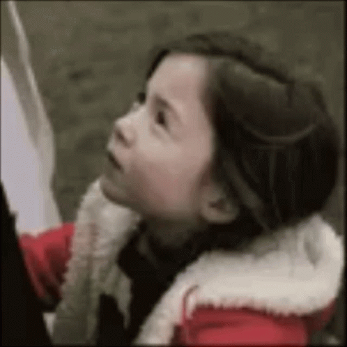 Little Girl in Red Jacket Looking Up