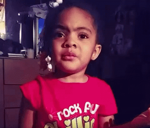 Little Girl in Red Rock On Shirt Making Funny Face