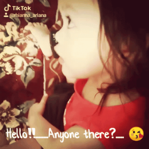 Little Girl in Red Shirt Saying Hello Anyone There