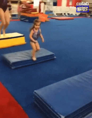 Little Girl Jumping Over Mat