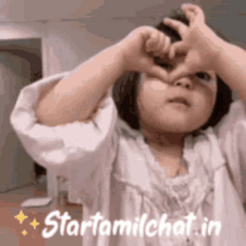 Little Girl Making Heart Shape With Hands