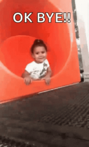 Little Girl on Orange Slide Saying Ok Bye