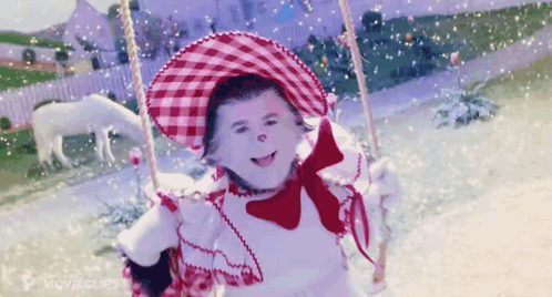 Little Girl on Swing with Red and White Hat