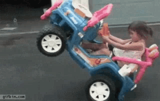 Little Girl Riding Blue Toy Jeep