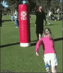 Little Girl Running Toward Red Punching Bag Saying R.N.T