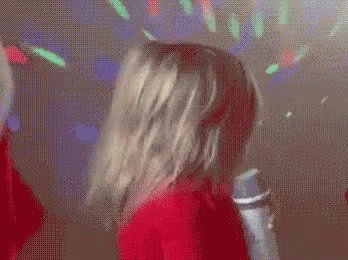 Little Girl Singing Into Microphone in Club