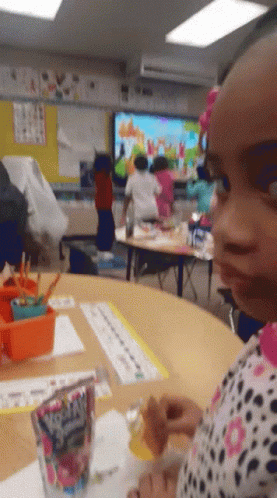 Little Girl Sitting At Table With Fruity Pebbles GIF