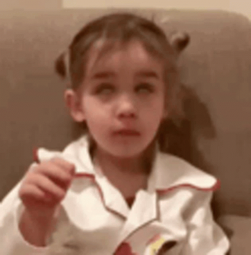 Little Girl Sitting in Chair Holding Paper