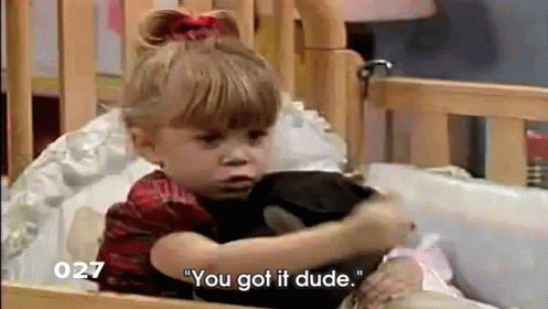 Little Girl Sitting in Crib Saying You Got It Dude