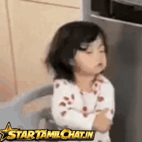 Little Girl Sitting in Front of Star Tamilchat.in Sign