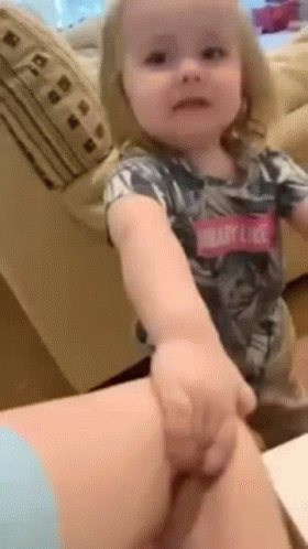 Little Girl Sitting on Woman's Lap Holding Hand
