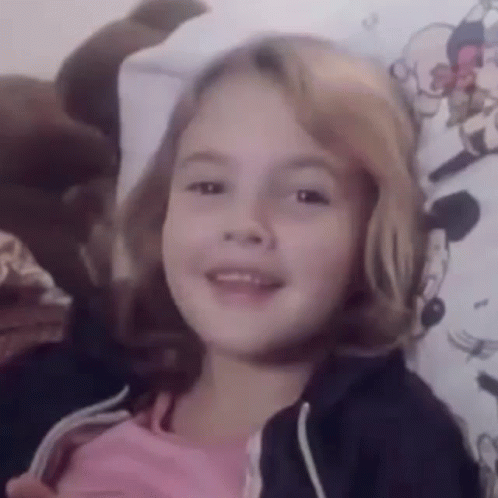 Little Girl Smiling on Bed