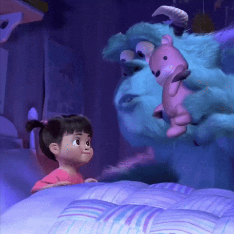 Little Girl Standing Next to Stuffed Animal in Bed