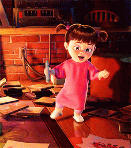 Little Girl Standing on Wooden Table in Pink Sweater