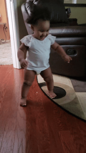 Little Girl Walking on Rug Smiling