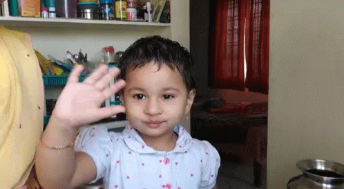 Little Girl Waving Hand in Room