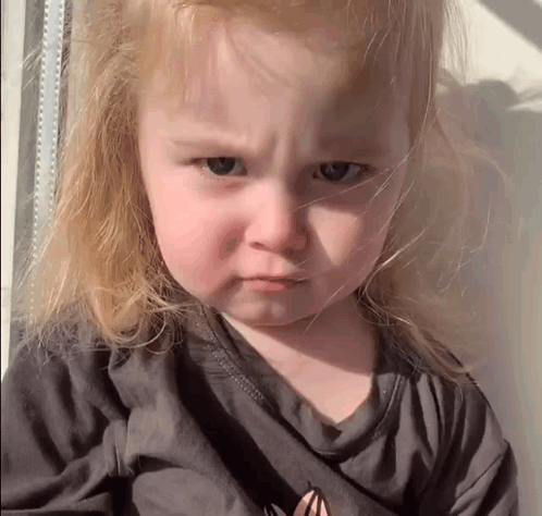 Little Girl With Blonde Hair Making Sad Face GIF