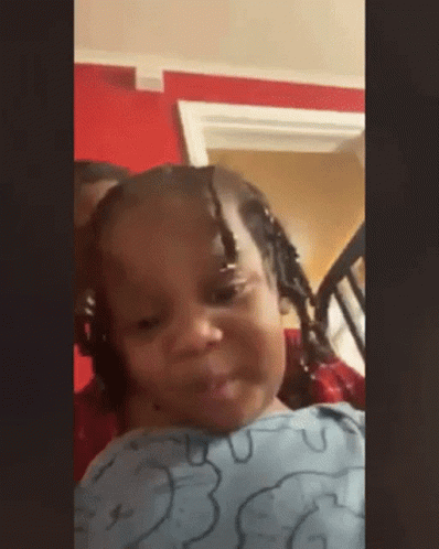 Little Girl With Braids Sitting In Chair Making Face GIF