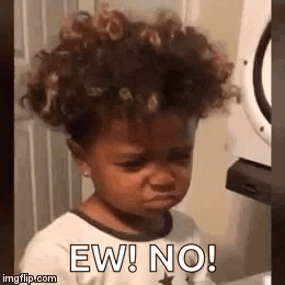 Little Girl With Curly Hair Making Funny Face by Washing Machine