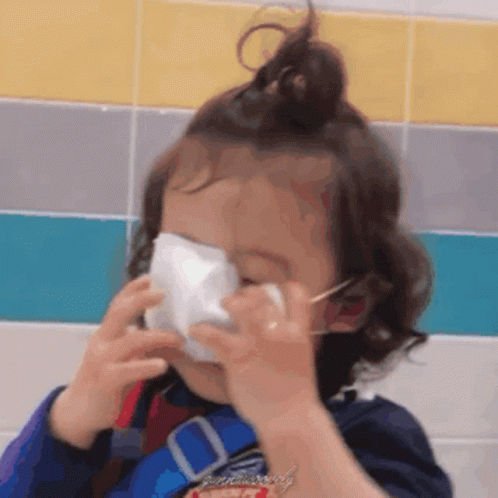 Little Girl With Face Mask at Tiled Wall