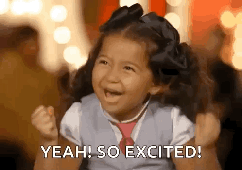 Little Girl With Pigtails and Tie Smiling Saying Yeah So Excited