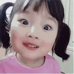 Little Girl With Pigtails Making Funny Face GIF