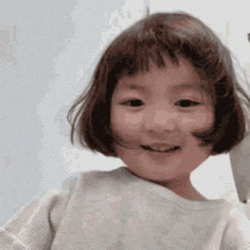 Little Girl with Short Hair and Bangs Smiling