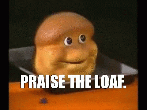 Loaf of Bread With Face and Words Praise the Loaf