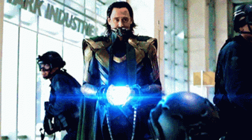 Loki From Avengers : Age Of Ultron Is Standing In Front Of A Building Holding A Light . GIF