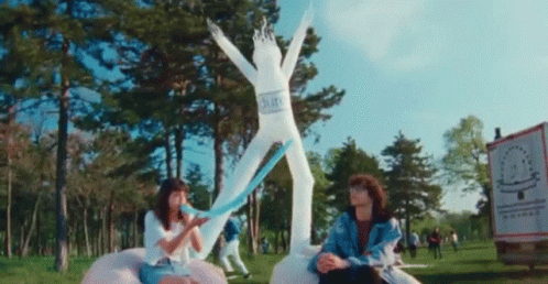Long Blue Balloon Deflating In The Park GIF